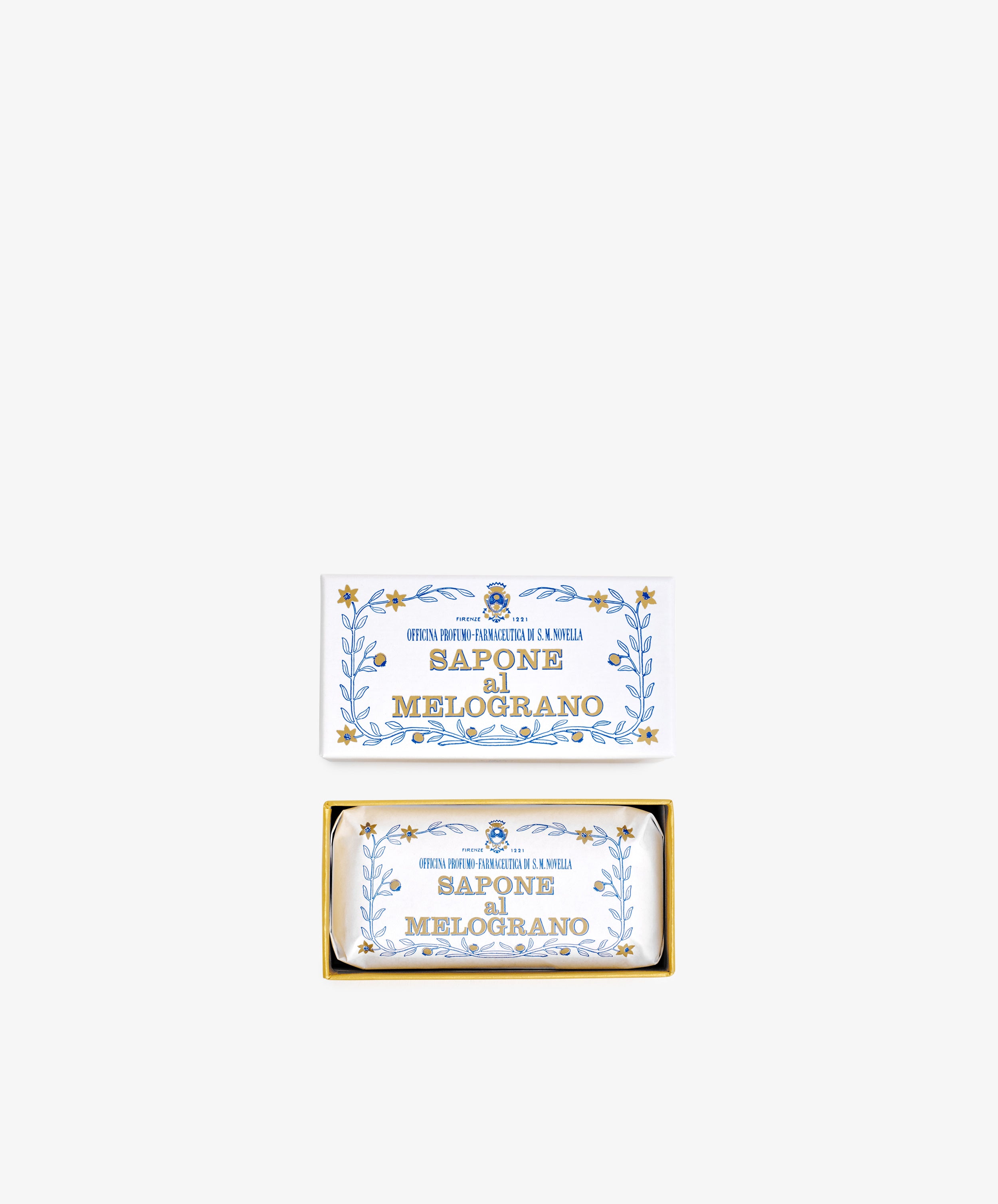 A rectangular box labeled Melograno Soap with blue and gold floral designs contains a matching wrapped Santa Maria Novella Melograno soap bar.