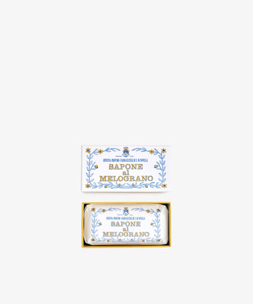 A rectangular box labeled Melograno Soap with blue and gold floral designs contains a matching wrapped Santa Maria Novella Melograno soap bar.