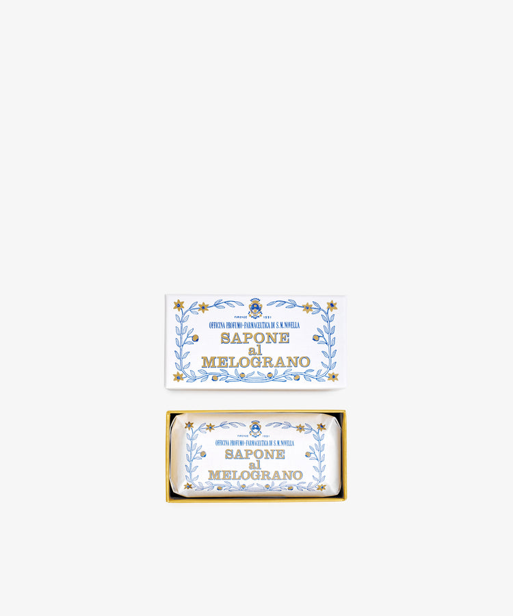 A rectangular box labeled Melograno Soap with blue and gold floral designs contains a matching wrapped Santa Maria Novella Melograno soap bar.