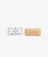 A rectangular Melograno Soap by Santa Maria Novella rests next to its decorative box labeled 