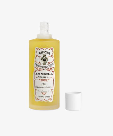 A 250 ml bottle of Dermoprotective Oil with the cap beside it on a white background—ideal for delicate skin thanks to nourishing sweet almond oil.
