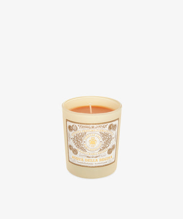 The Acqua Della Regina Candle features a beige wax in a glass holder with an ornate gold and white label, part of the Firenze 1221 Edition—a tribute to the Florentine fragrance tradition.