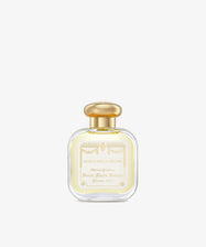 A clear glass bottle of Acqua Della Regina Eau de Cologne, a historic scent, features a gold cap and cream label with gold lettering and decorative accents.