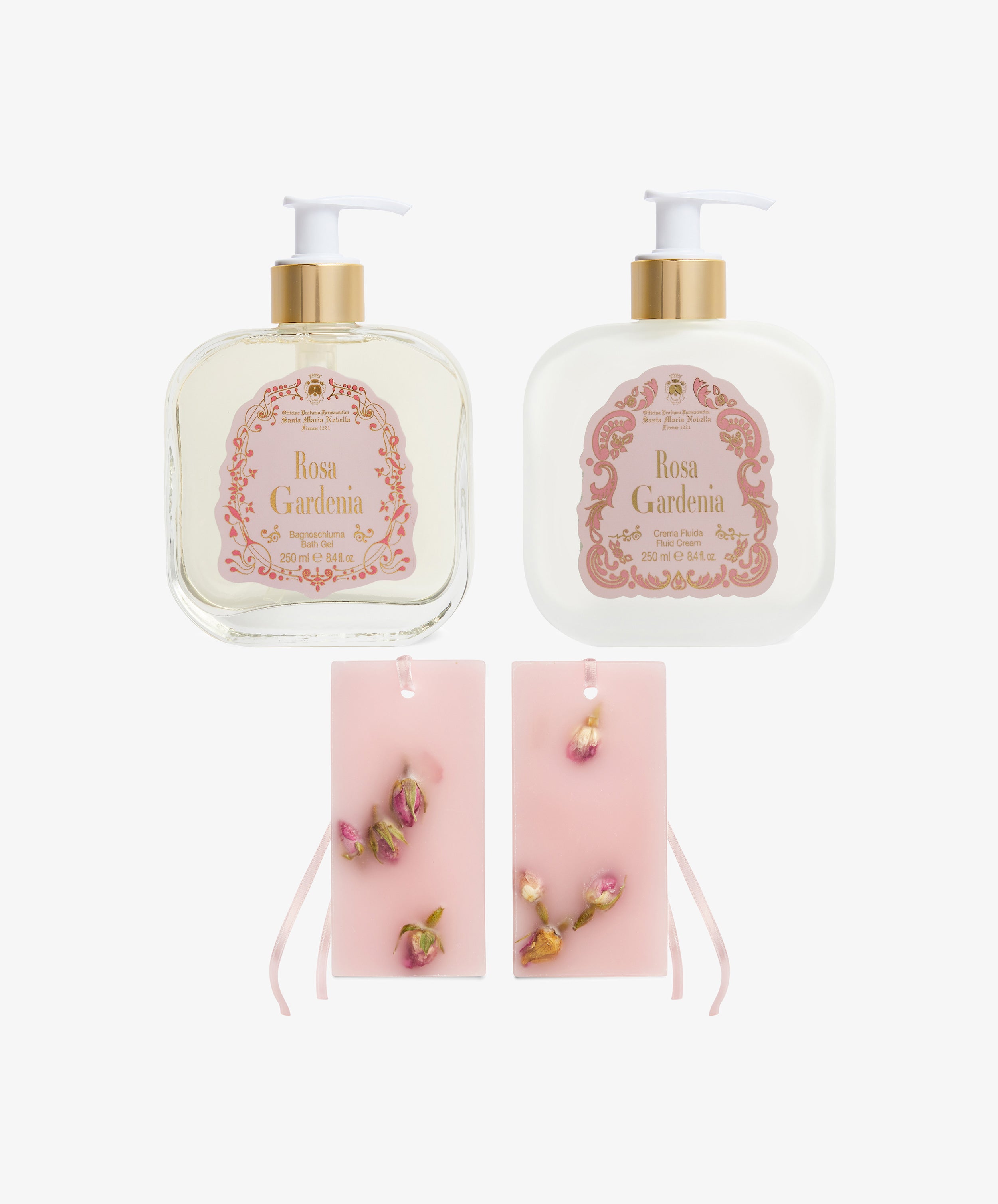 The Rosa Gardenia Bundle features two pump bottles with pink and gold designs and two pink wax tablets adorned with dried rosebuds, all infused with the delicate scents of Rosa Gardenia and sandalwood for a luxurious bath experience.