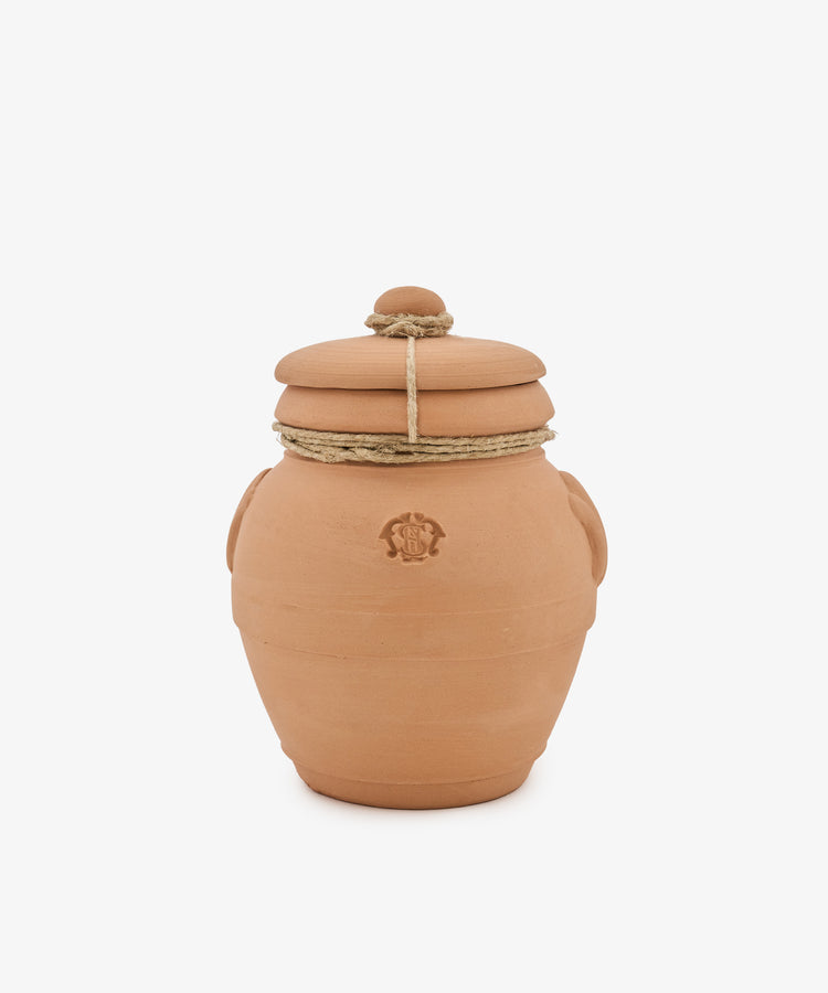 A Pot Pourri in Terracotta Jar, featuring a brown clay body with a lid, two side handles, and rope tied around the neck—evoking the look of vessels from historic apothecaries—set against a plain white background.