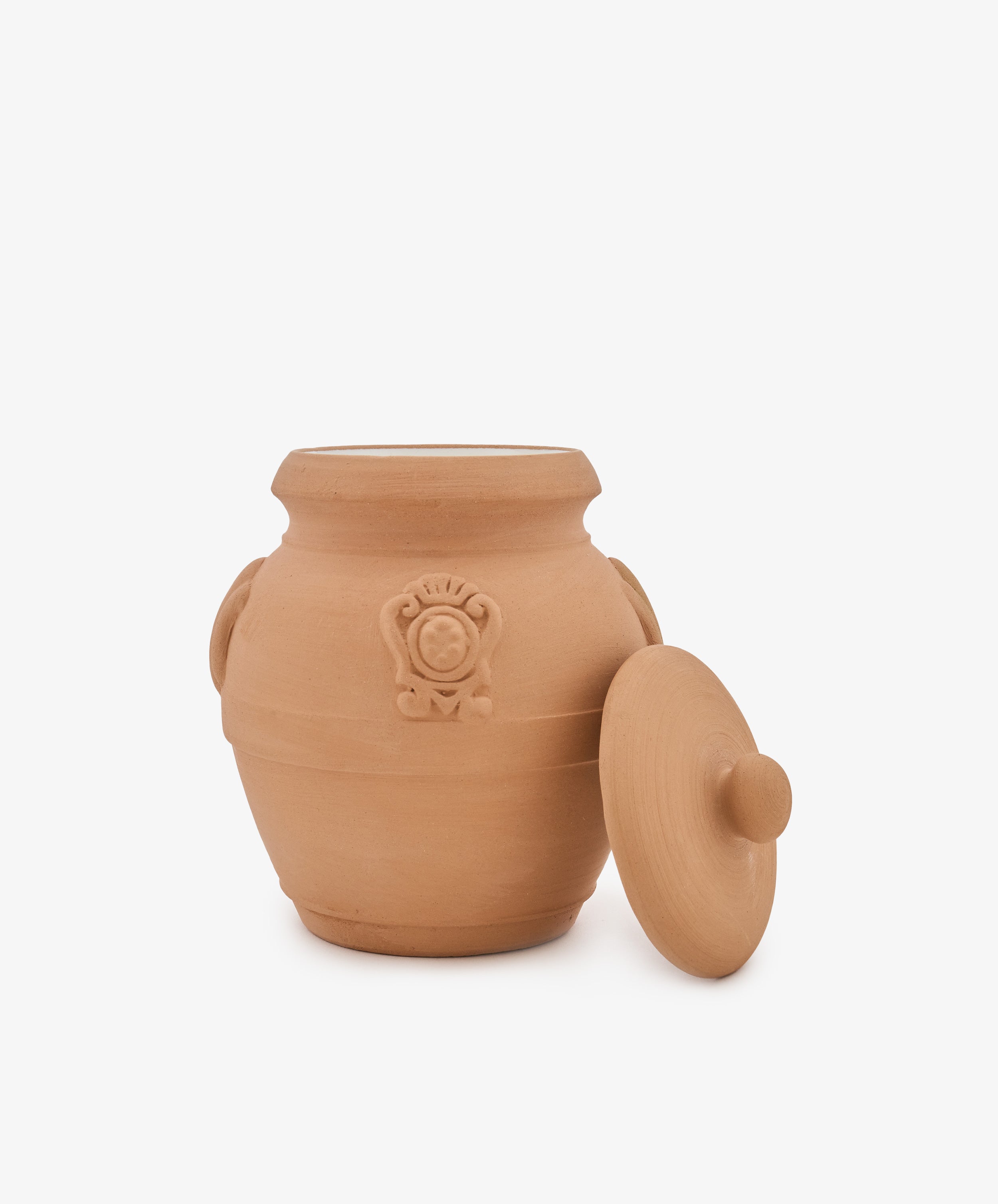Pot Pourri in Terracotta Jar featuring an unglazed clay vessel with two side handles, a round embossed design on the front, and a matching lid resting at an angle—capturing the timeless allure of jars once used in historic pharmacies to store prized herbal blends and traditional formulas.