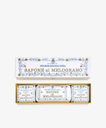 The Melograno Soap Set features three wrapped soaps labeled “Sapone al Melograno” in packaging adorned with blue and gold floral patterns inspired by Florentine paper.