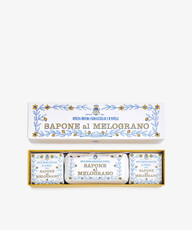 The Melograno Soap Set features three wrapped soaps labeled “Sapone al Melograno” in packaging adorned with blue and gold floral patterns inspired by Florentine paper.