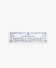 The Melograno Soap Set features rectangular bars labeled SAPONE al MELOGRANO, adorned with gold stars and blue leaf patterns inspired by Florentine paper on a white background.