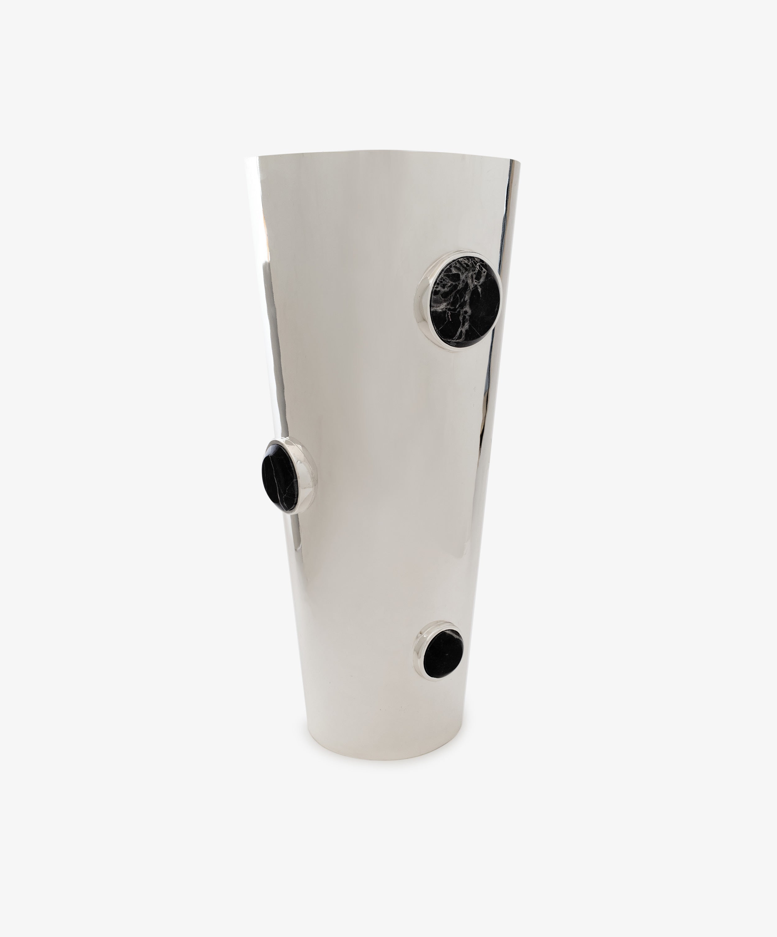 Paros Cone Vase: A tall, shiny steel vessel featuring three round black marble accents arranged at different heights along its sleek surface, set against a plain white background. The Paros Cone Vase seamlessly blends modern elegance with bold contrast, making a dramatic decorative statement.