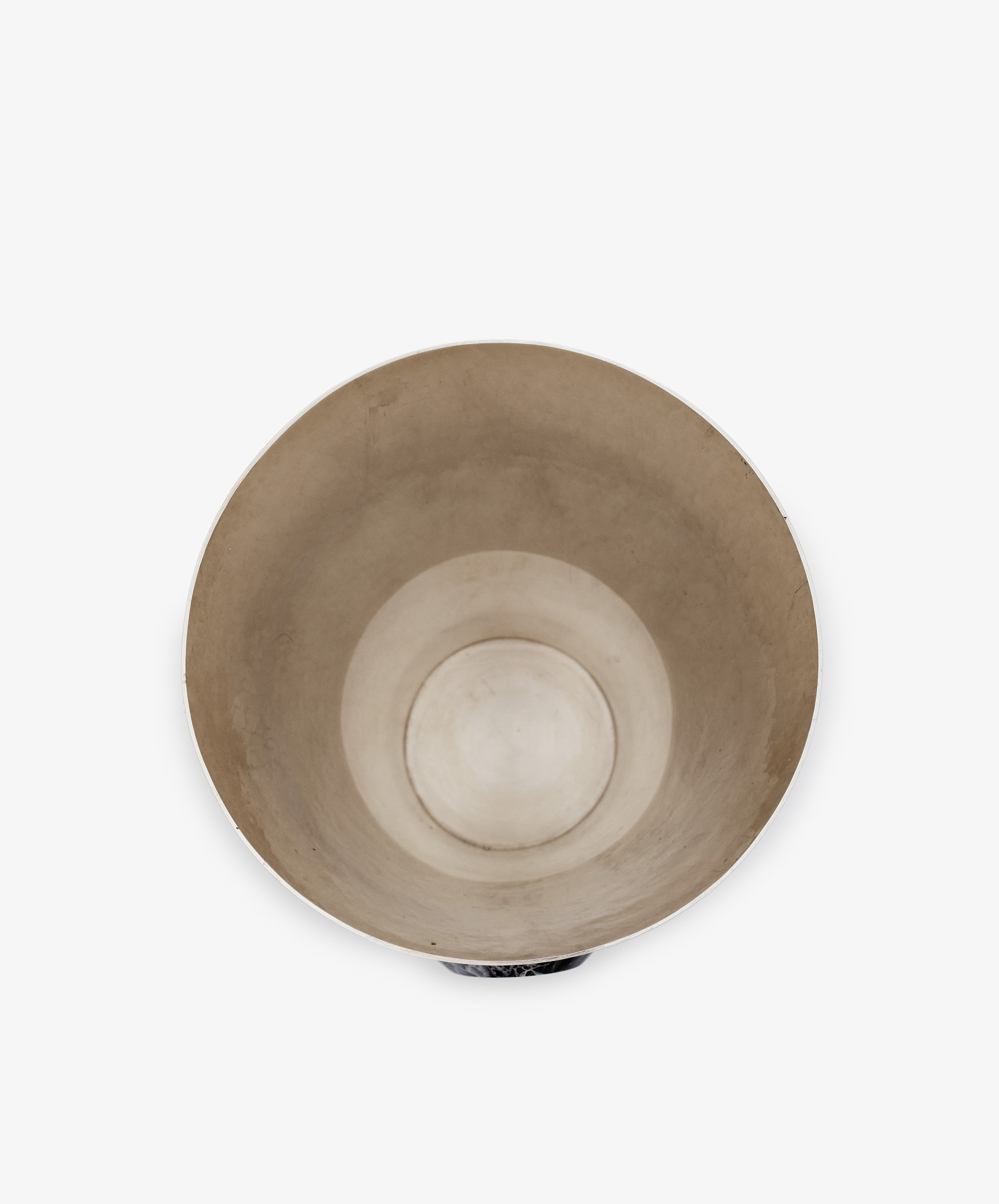 A top-down view of the Paros Cone Vase—an empty, round, beige vessel with a subtle concentric design—set against a plain white background; its refined form and elegant simplicity evoke the timeless appeal of marble.