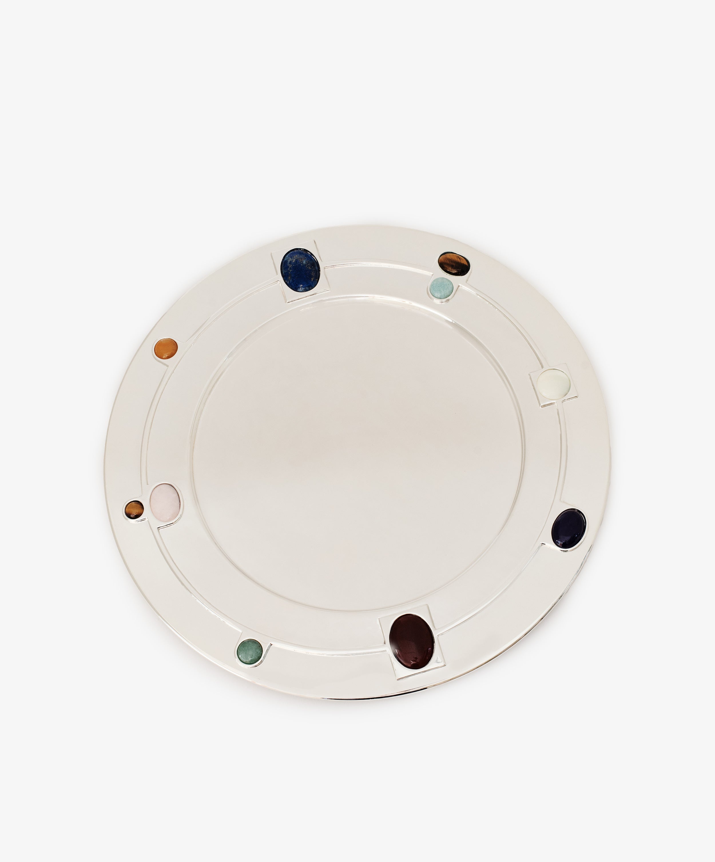 The Verola Round Tray is a white, circular tray adorned with evenly spaced colored stones embedded along its rim, evoking the look of an elegant colored stone ring, and is shown against a plain white background.