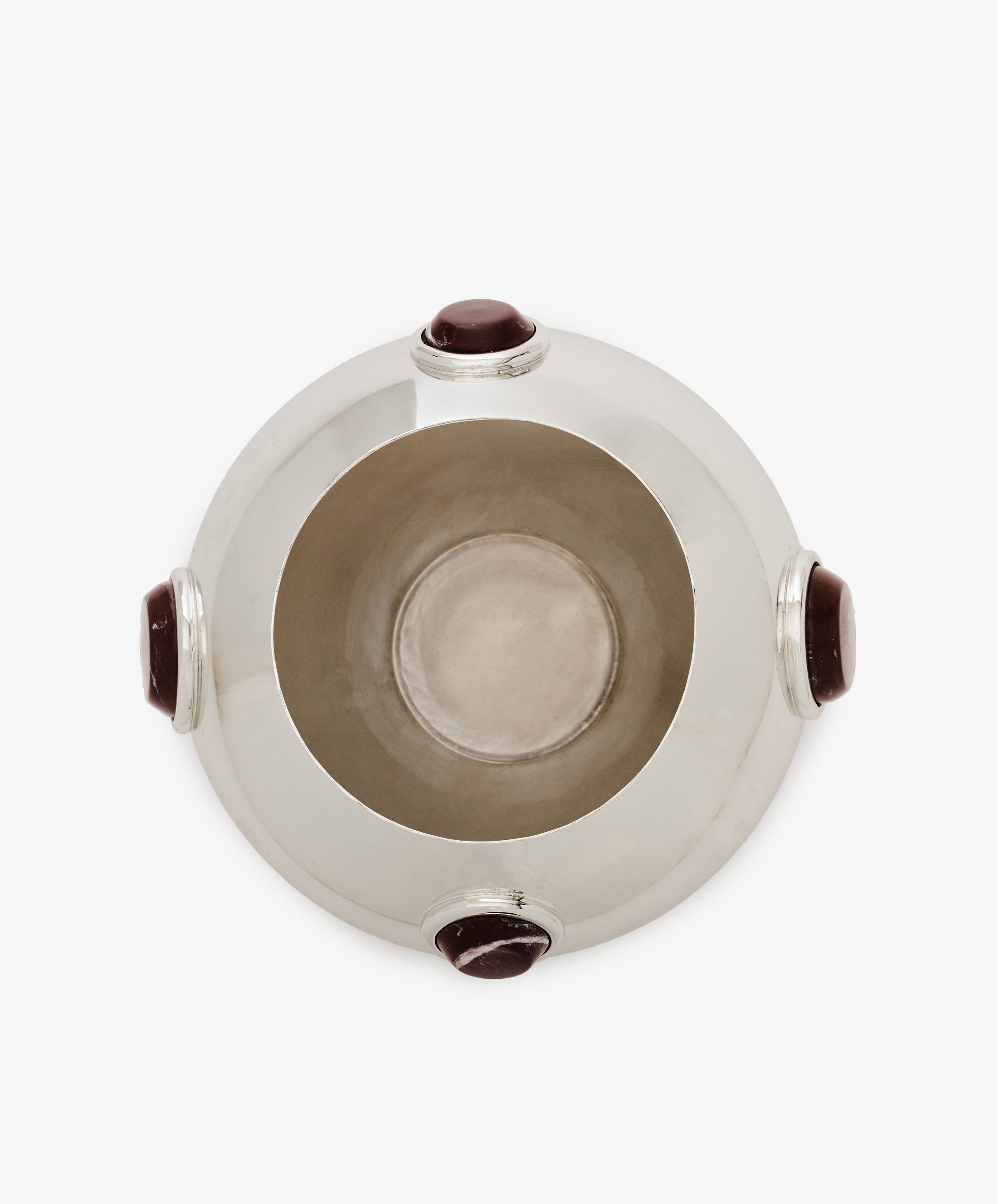 The Paros Round Vase is a silver-toned, round vase with a wide opening, viewed from above and accented by four evenly spaced dark oval stones around its rim—ideal for complementing marble decor or enhancing Paros stone surfaces.