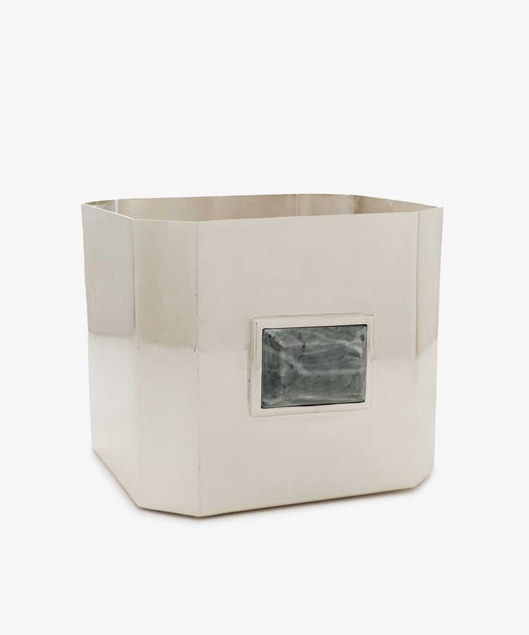 Paros Square Vase—a silver-colored metal container with a shiny finish and a rectangular, marbled green stone accent on one side, evoking the style of a Brancusi vase.