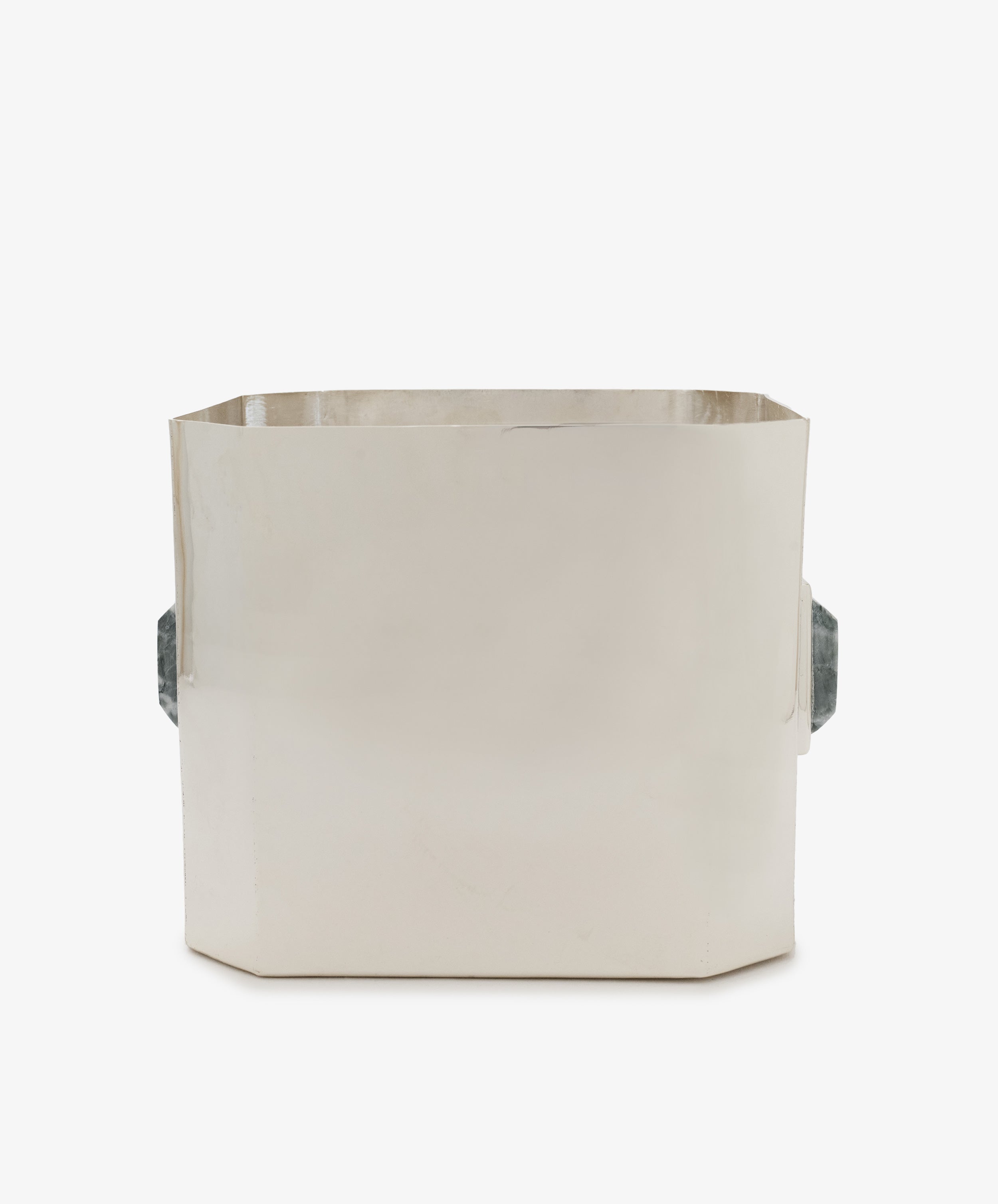 The Paros Square Vase is a rectangular, metallic container with flat sides, an open top, and two gray handles on each end, reminiscent of a Brancusi vase, shown against a plain white background.