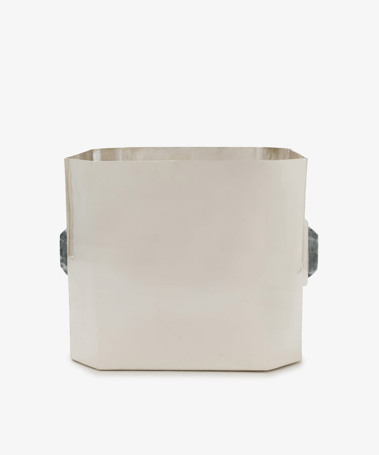 The Paros Square Vase is a rectangular, silver-plated brass container featuring two dark, textured side handles, displayed against a plain white background.