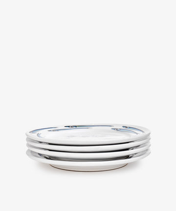 A set of four Tommaso Dinner Plates in white ceramic featuring a minimal blue rim pattern, stacked together on a plain white background.