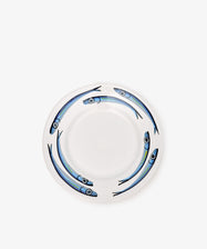 The Tommaso Small Plate, Set of 4, features white ceramic plates with four blue fish swimming in a circular pattern along the rim, inspired by hand-painted designs from the Amalfi Coast.