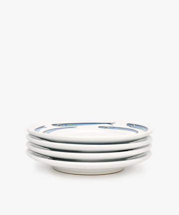 The Tommaso Small Plate, Set of 4, features hand-painted blue fish along the rims on a plain white background—evoking the charm of the Amalfi Coast.