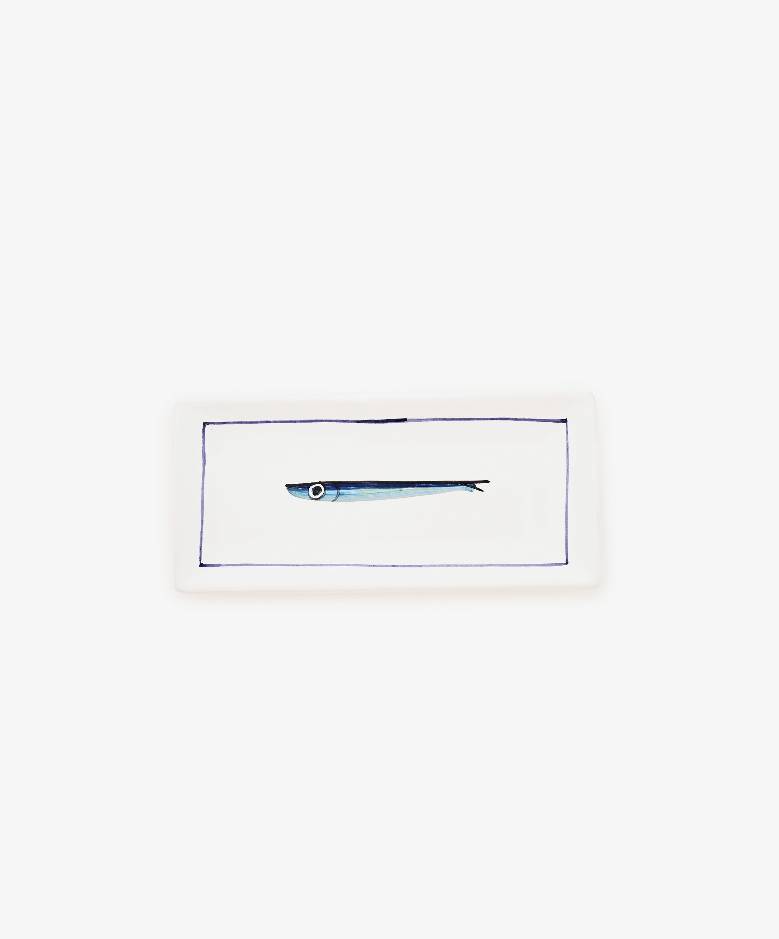 The Tommaso Rectangle Tray is a white ceramic serving tray featuring a simple illustration of a small cobalt blue fish in the center, framed by a thin blue border.