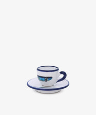 The Tommaso Espresso Set features a white ceramic cup with a blue handle and rim on a matching saucer, both accented in blue and showcasing a geometric pattern inspired by the Mediterranean charm of the Amalfi Coast.