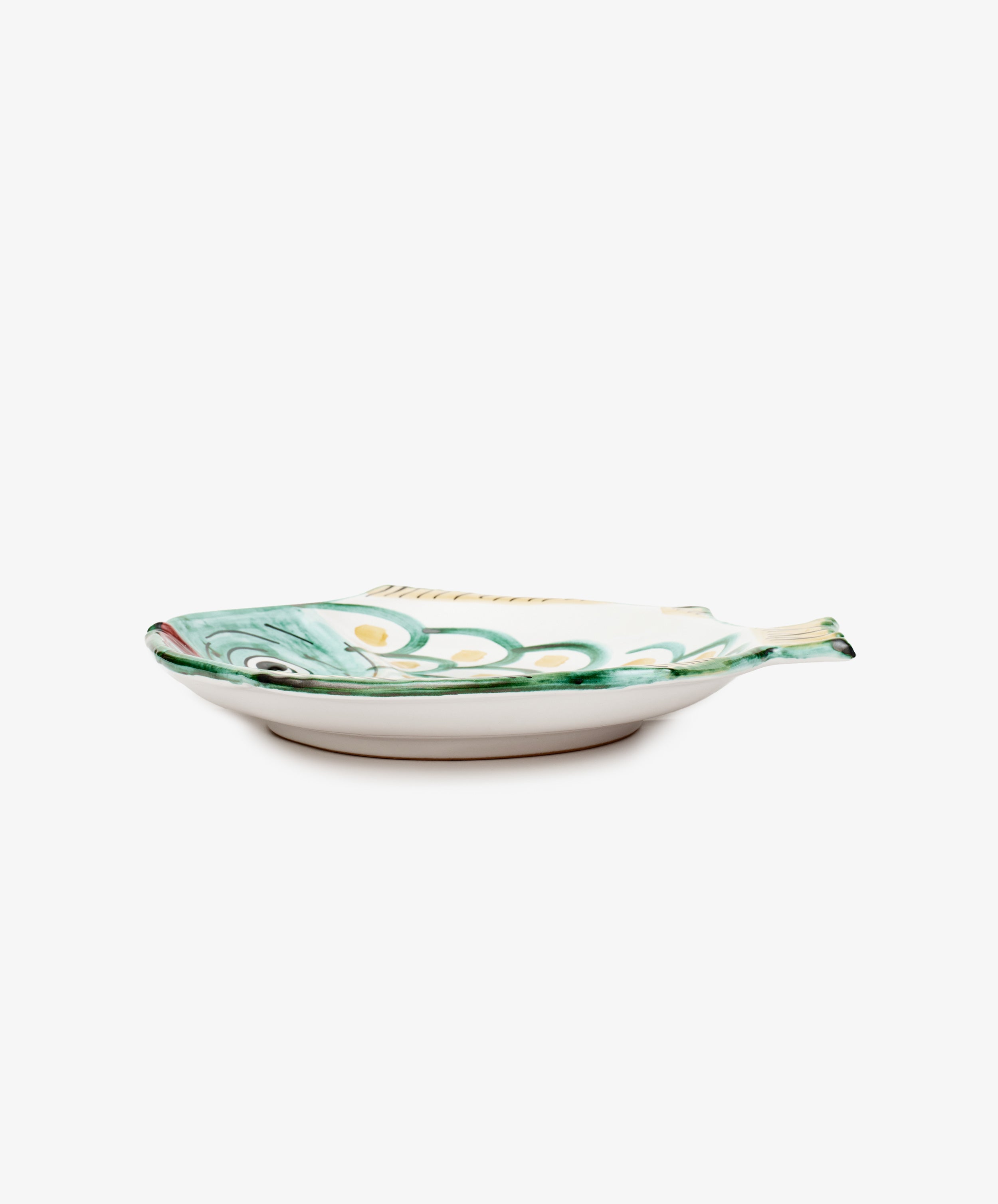 Rico Serving Platter. Small glazed ceramic fish-shaped plate, side view.