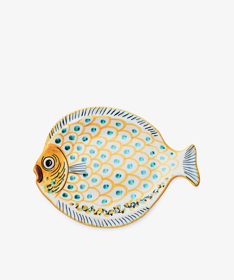 The Ricardo Serving Platter is shaped and painted like a fish with yellow, blue, and white scales plus a detailed face and tail—a playful dish to add color to your table.