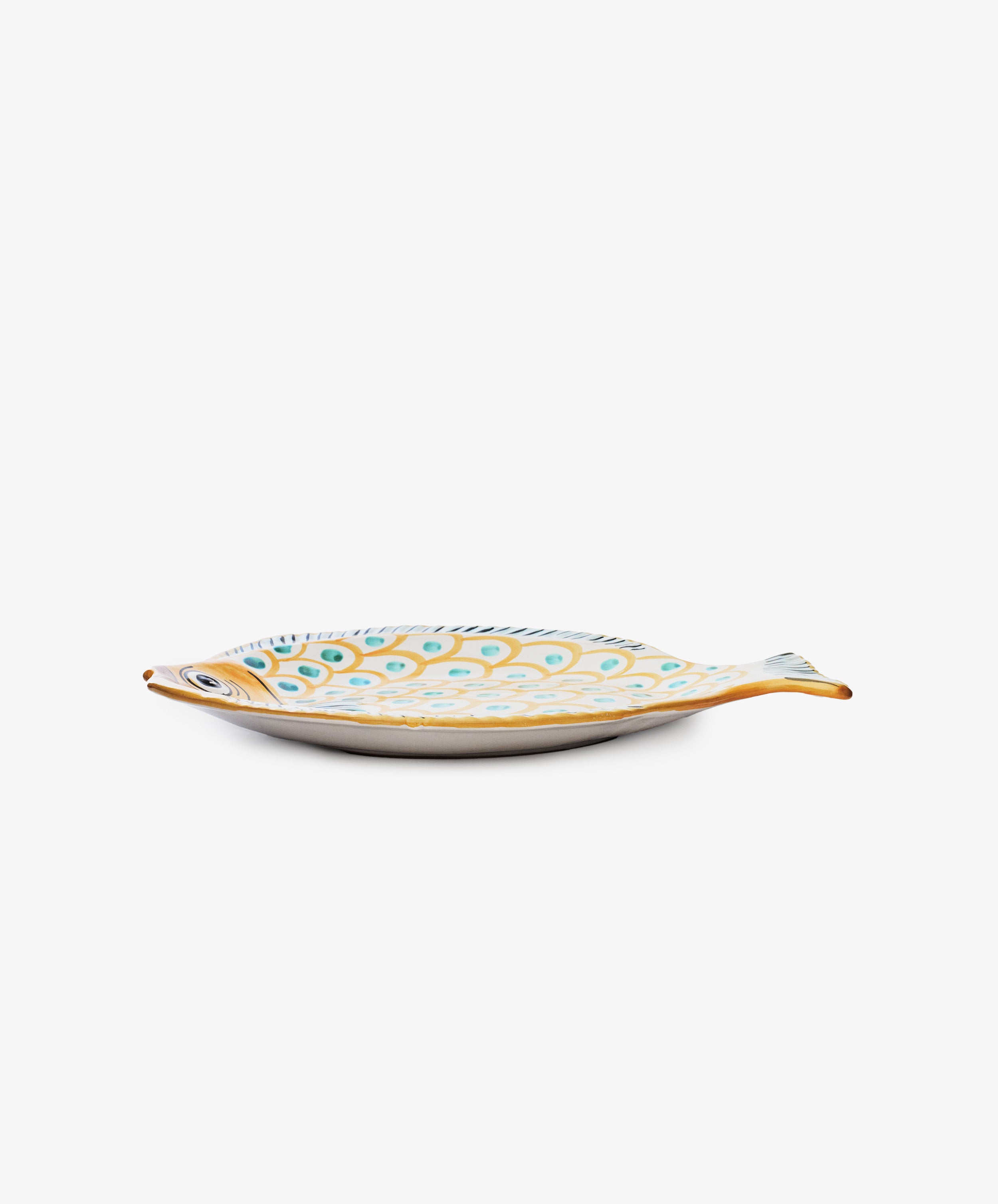 The Ricardo Serving Platter, an oval ceramic dish shaped like a fish and painted with blue, yellow, and orange patterns, adds a playful touch to any table and stands out beautifully against a white background.