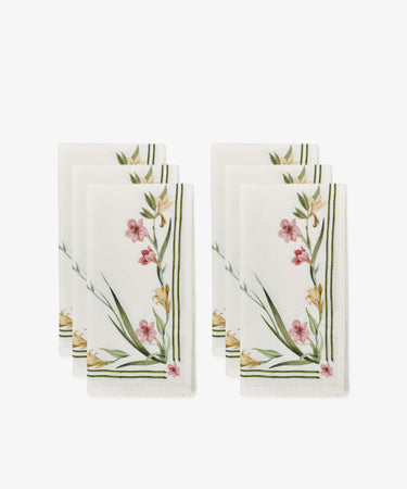 Set of 6 Gladioli Napkins—white cloth with pink, yellow, and green botanical gladioli patterns and green striped borders—arranged in two stacks. Ideal for vibrant table decor or pairing with a matching tablecloth.