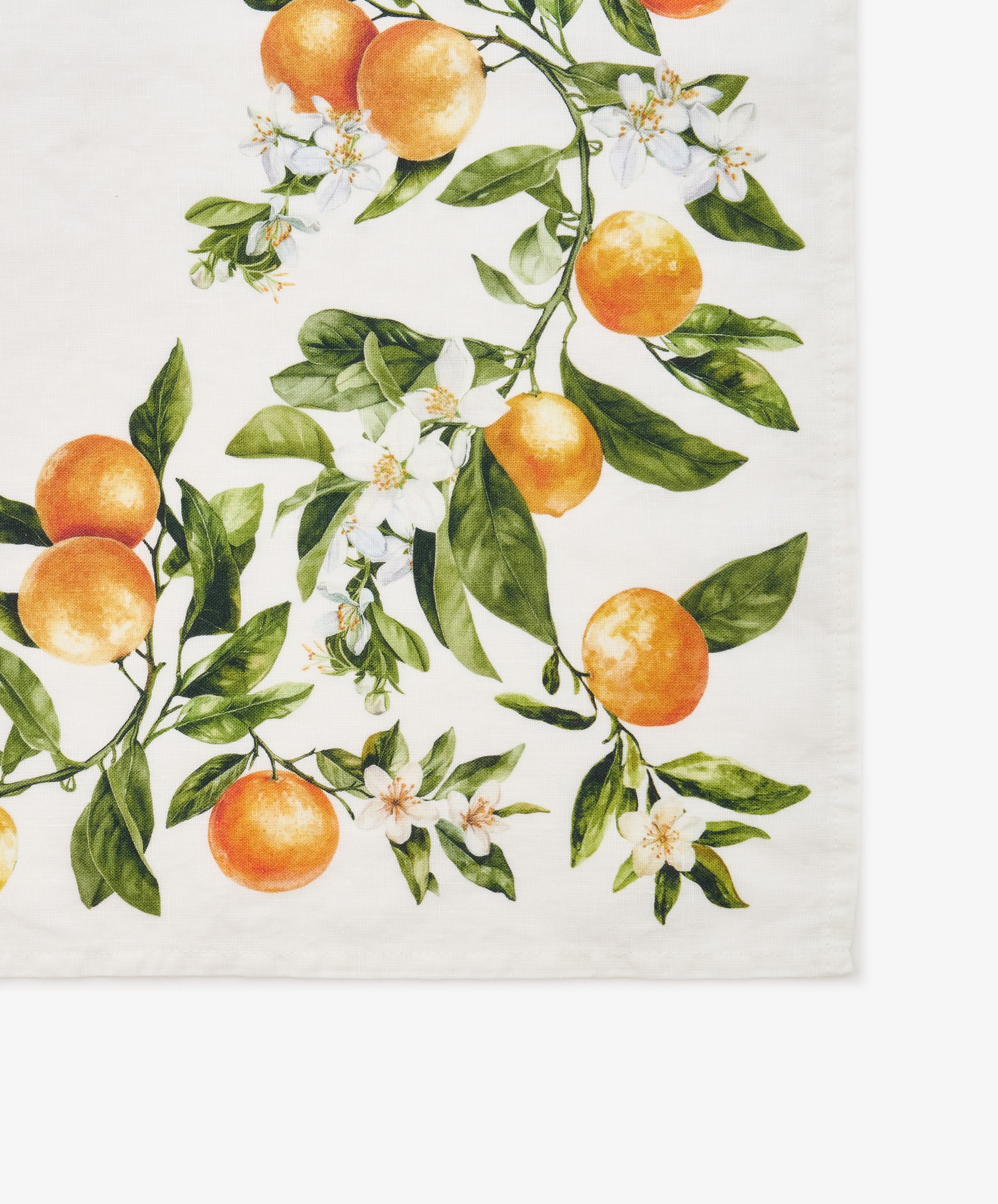 The L’Orangerie Napkin, Set of 6 features a printed design of oranges, green leaves, and white blossoms on a crisp white background, capturing the elegance of classical French garden motifs. Reminiscent of exquisite French linen napkins from Le Jacquard Français, this set brings timeless charm to any table setting.