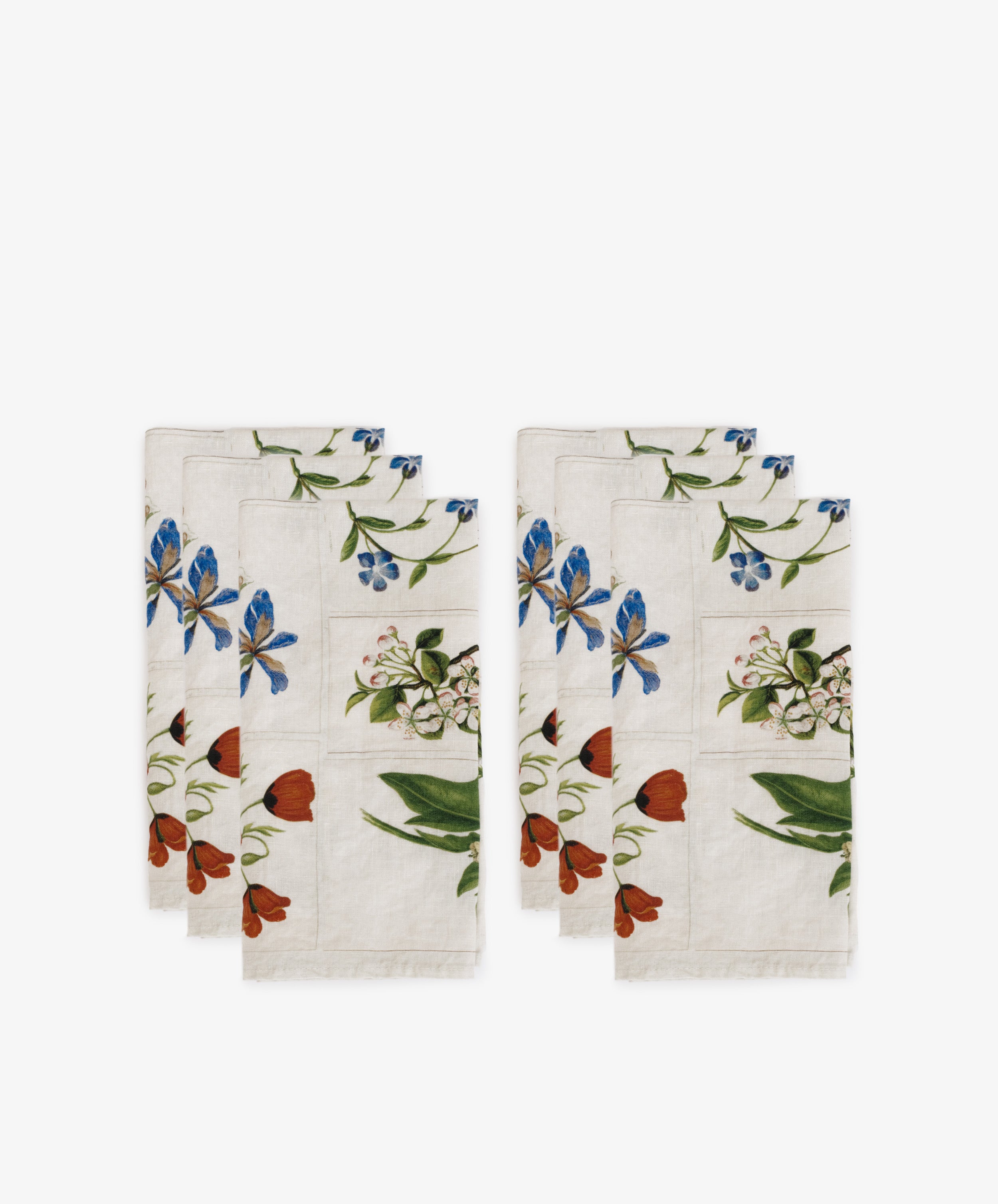 The John Derian Botanical Tiles Napkin set includes six linen napkins with blue, red, and green floral patterns, displayed in two stacks on a white background.