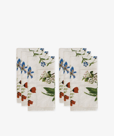 The John Derian Botanical Tiles Napkin set includes six linen napkins with blue, red, and green floral patterns, displayed in two stacks on a white background.