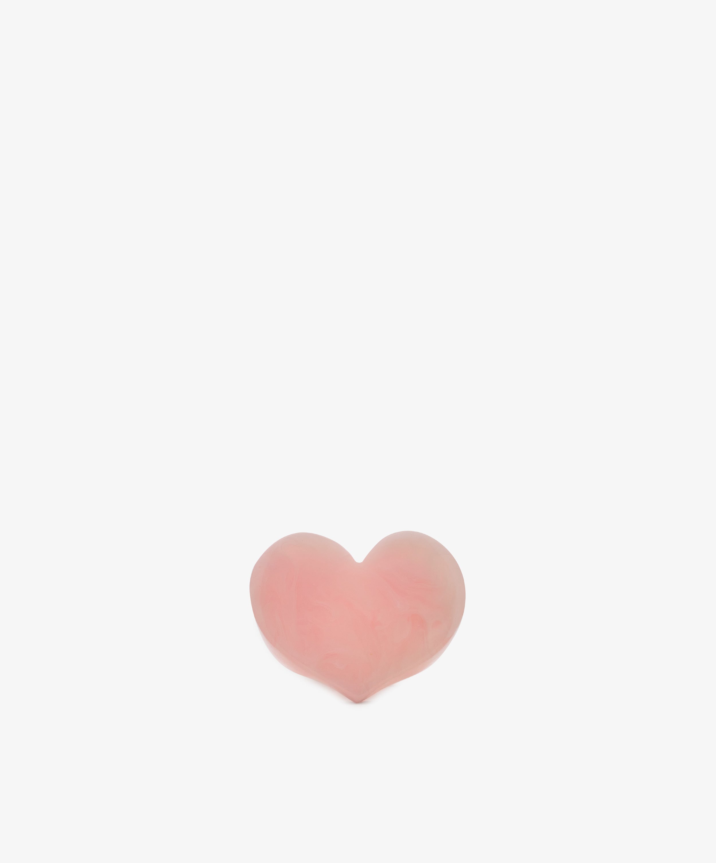 A small, pink Heart Resin Napkin Ring is centered on a plain white background.