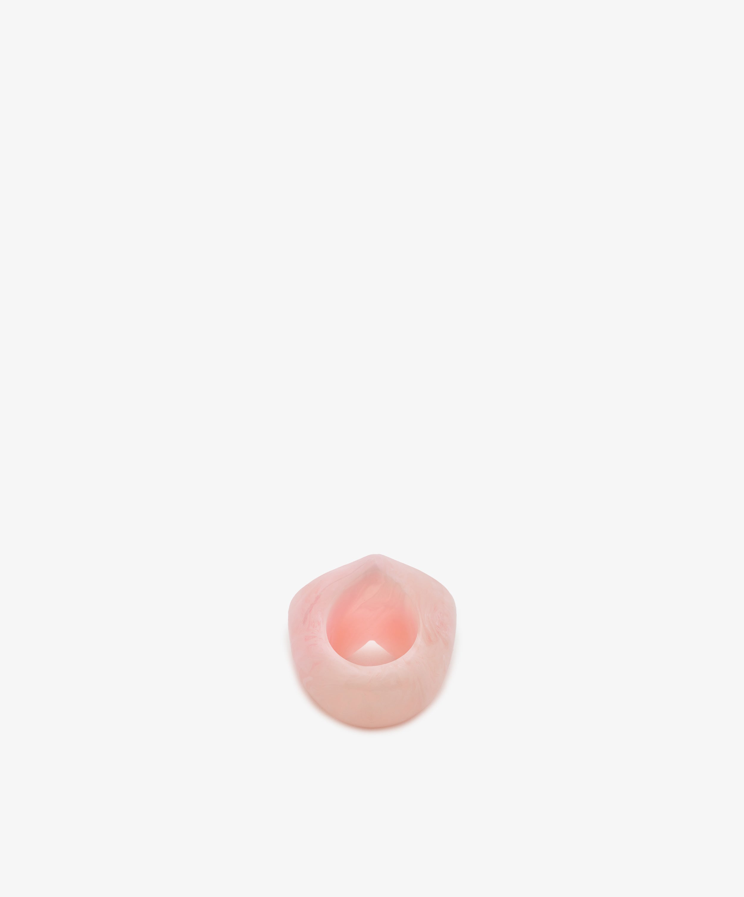 A Heart Resin Napkin Ring, small and pink with an open center, is positioned on a plain white background.