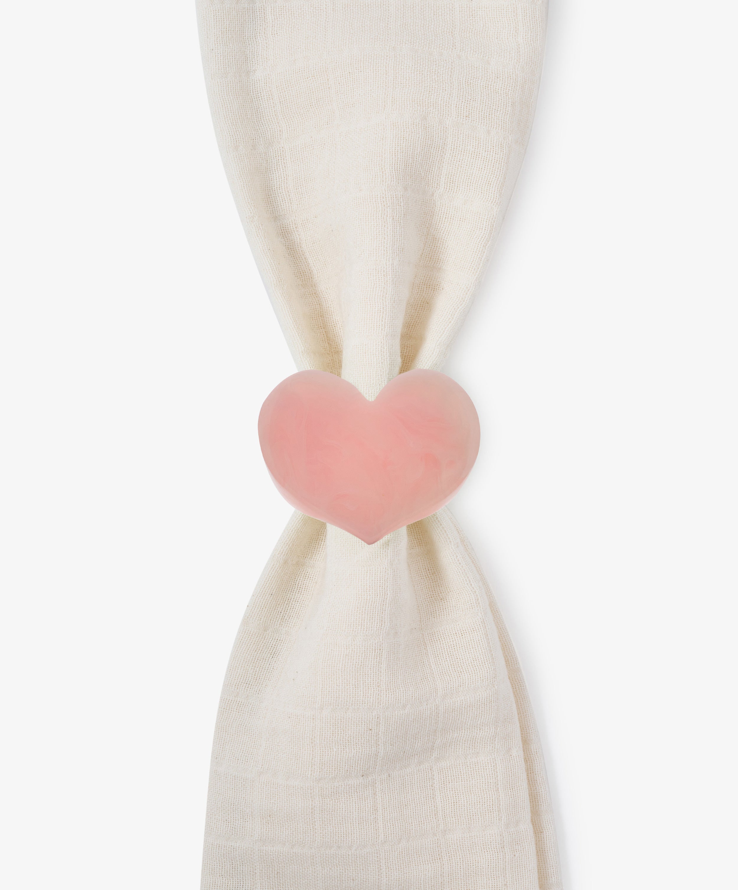 A white cloth is gathered and held together by the Heart Resin Napkin Ring—a pink, heart-shaped clip crafted from smooth resin—creating a sculptural form that doubles as a charming love decor accent.