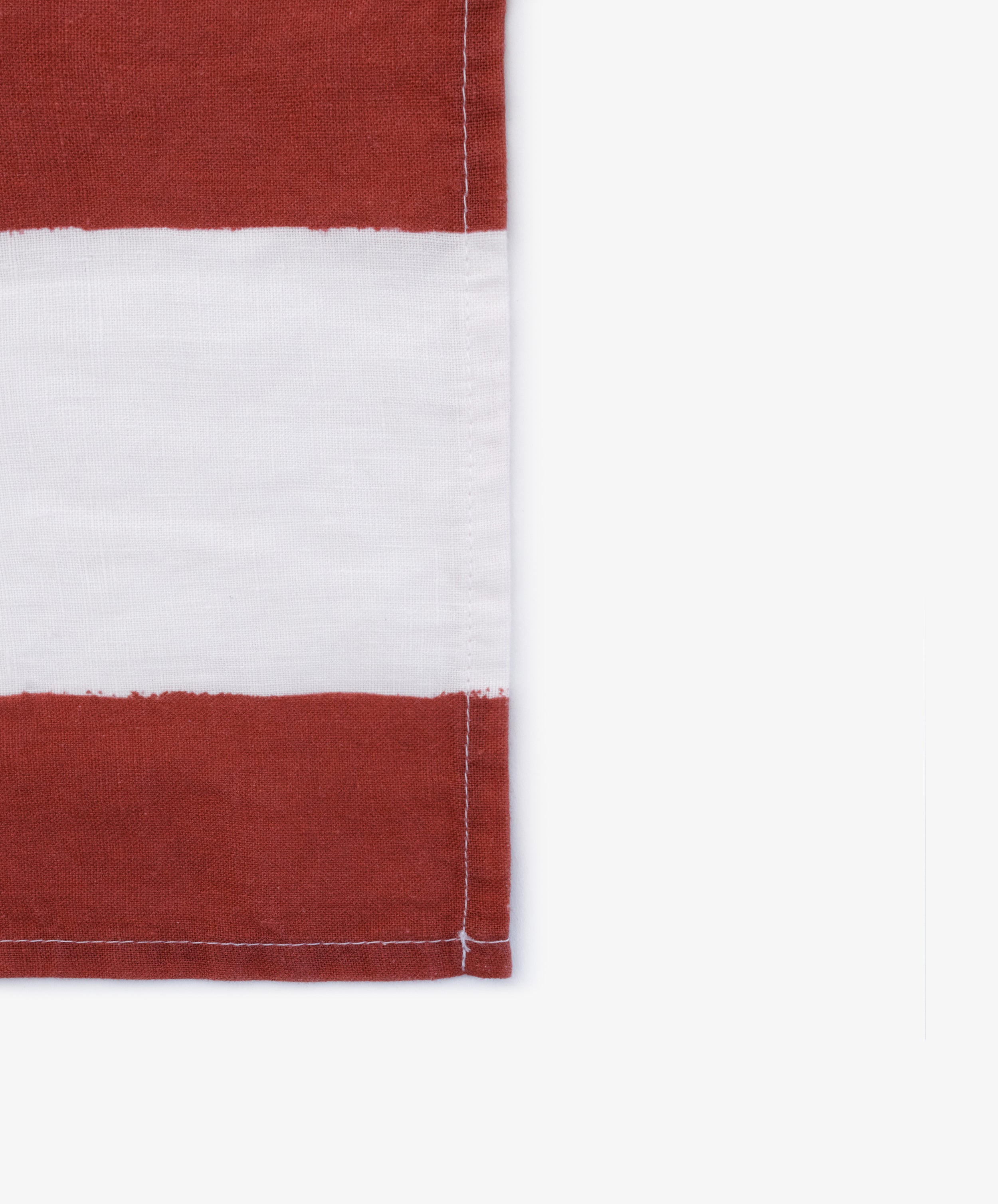 A close-up of a fabric with horizontal red and white stripes and visible edge stitching, resembling the Striped Napkins, Set of 6.