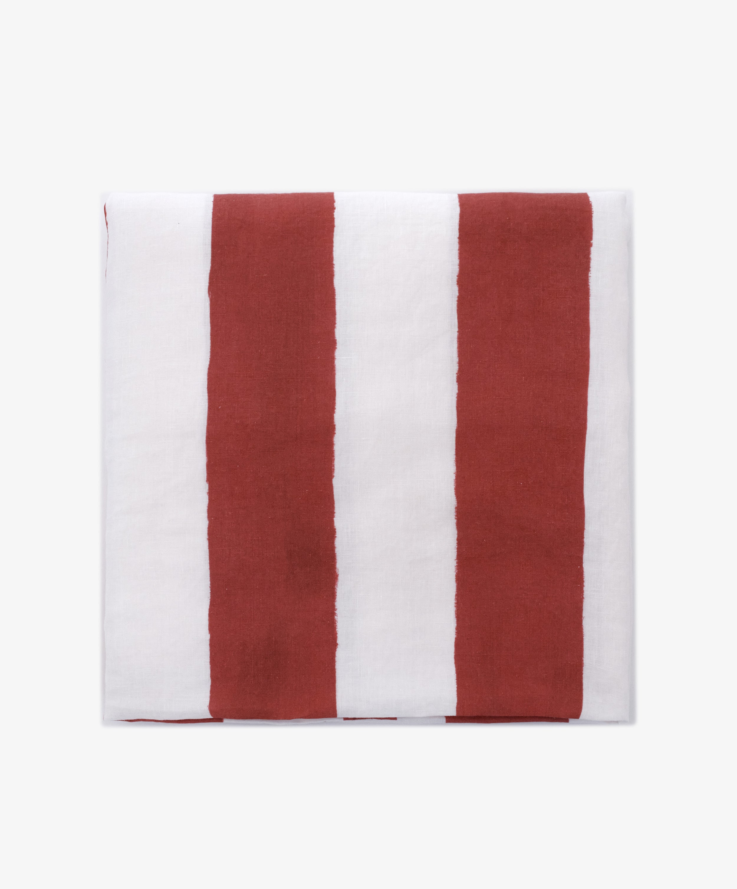 A folded Striped Tablecloth from Summerill & Bishop, showcasing an alternating pattern of vertical red and white stripes.