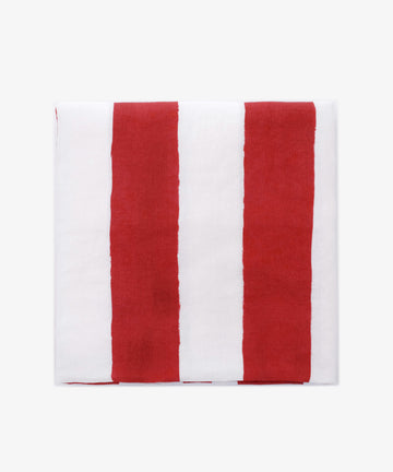 A neatly folded Striped Tablecloth by Summerill & Bishop, displaying vertical red and white stripes on a plain white background.