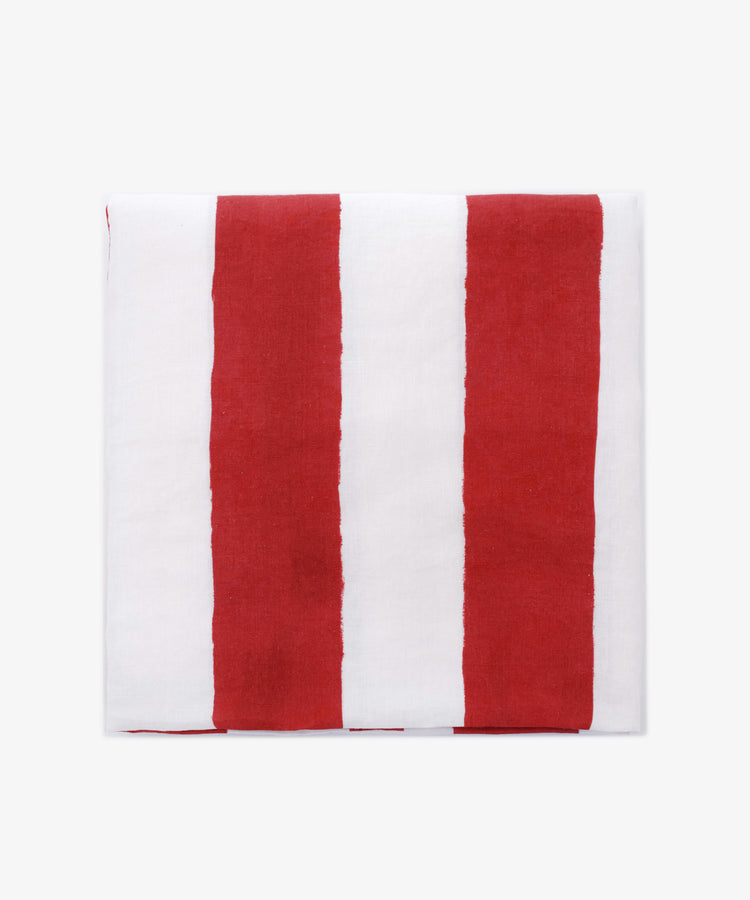 A neatly folded Striped Tablecloth by Summerill & Bishop, displaying vertical red and white stripes on a plain white background.