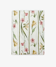 Gladioli Tablecloth—a folded white tablecloth with a gladioli design, showcasing pink and yellow flowers with green leaves in vertical lines. Ideal for adding vibrant style to your table decor.