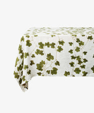 Ivy Herbarium Tablecloth. Ghost image of tablecloth draped over a table. Side view.
