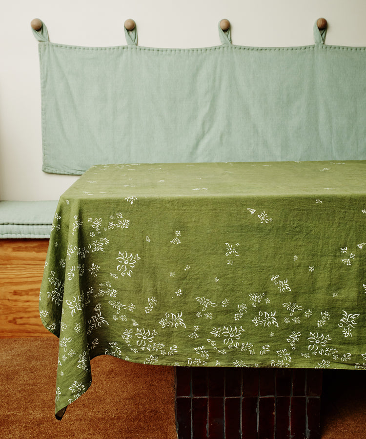 S&Bee Tablecloth. Image of tablecloth draped over a table. Side view.