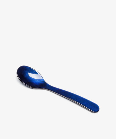 The Piccolo Spoon, featuring a glossy blue finish and expert craftsmanship, is displayed on a plain white background.