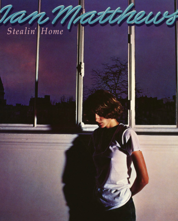 woman standing by window at night