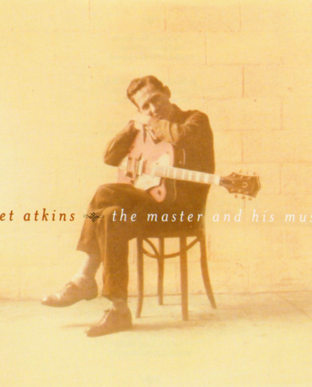 man sitting with guitar