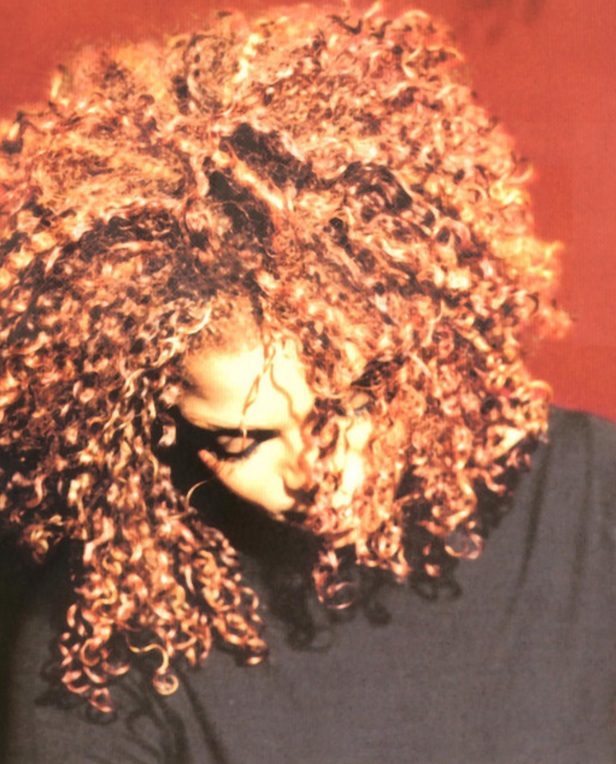 woman with curly hair looking down