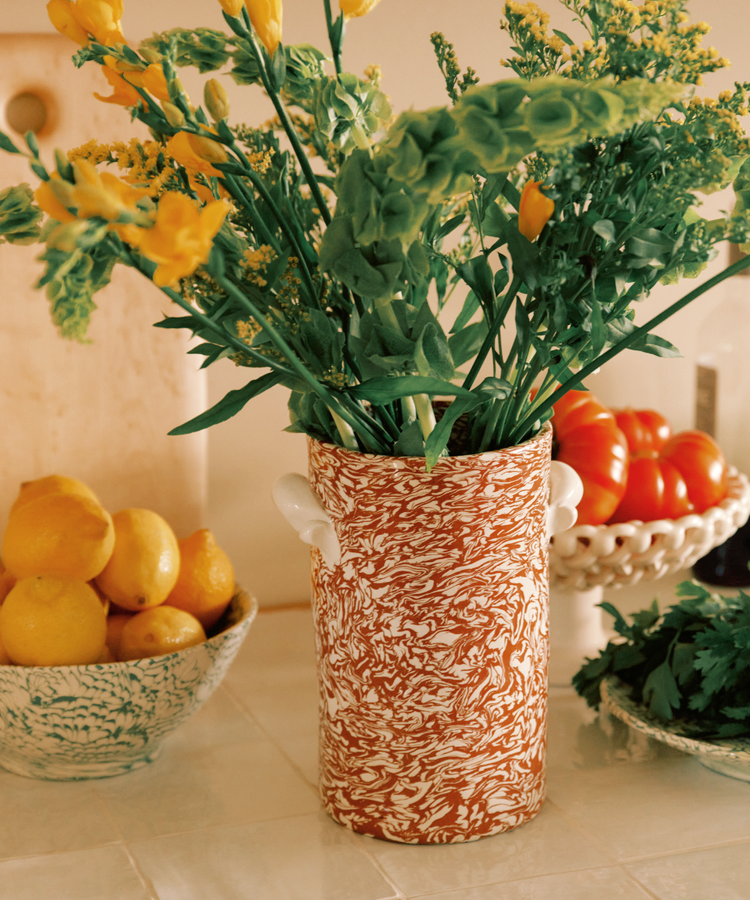 A Celine Wine Cooler sits on the kitchen counter, next to a bowl of lemons, fresh tomatoes on a stand, and a bunch of parsley.