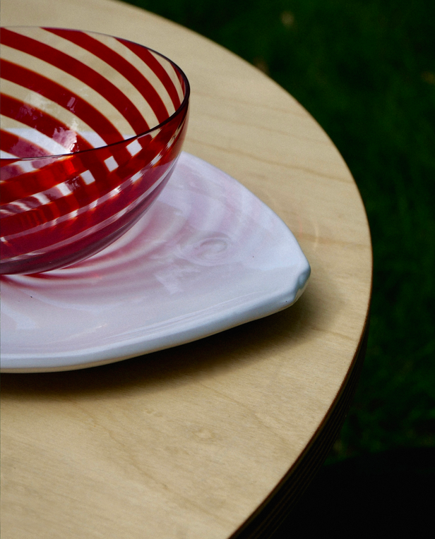 stripe glass bowl on top of white fish plate