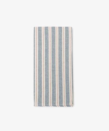 A Martin Striped Napkins set of 6, featuring folded blue and white stripes, rests on a plain white background and highlights the classic charm of durable cloth napkins.