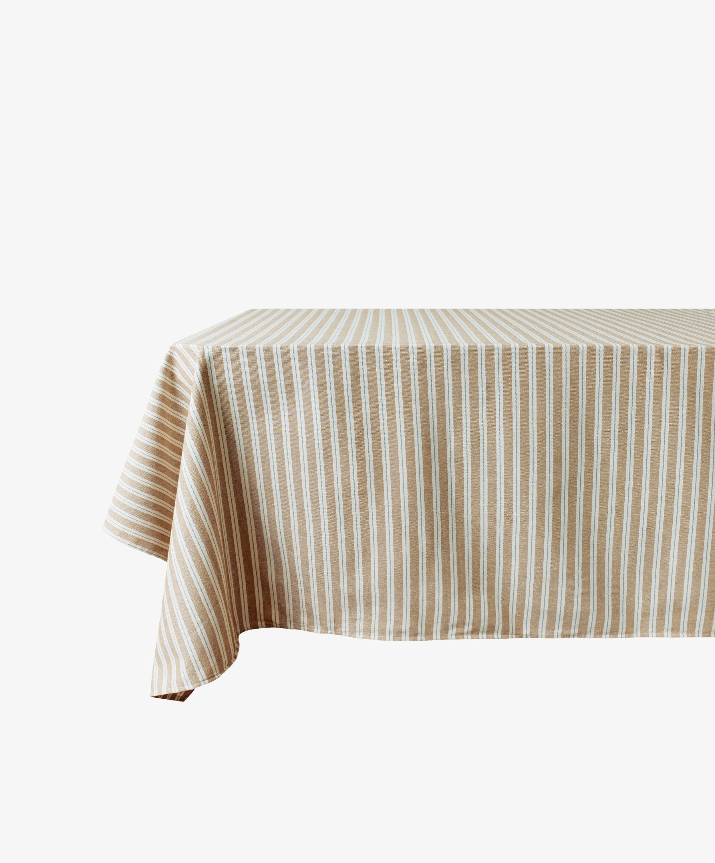 The Martin Striped Tablecloth, with its beige and white stripes, covers a rectangular table against a plain white background, highlighting the timeless charm of English ticking style.